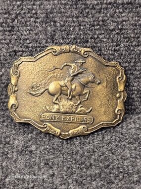 Vintage brass-tone Pony Express belt buckle featuring a cowboy on horseback